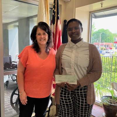 Melrose Housing Authority Housing Choice Voucher (HCV) Program Coordinator Erin Keating presents Family Self Sufficiency (FSS) Participant Etta Dunn with a check for $12,072.88 for completing the FSS contract of participation.